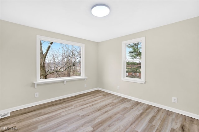 unfurnished room with light wood-type flooring