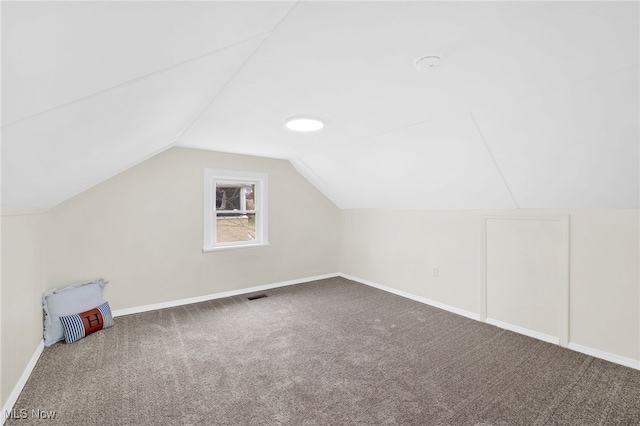 bonus room featuring carpet flooring and vaulted ceiling