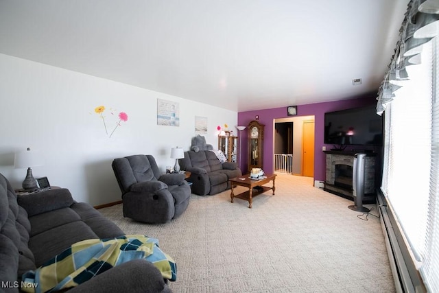 carpeted living room with a baseboard heating unit and a fireplace