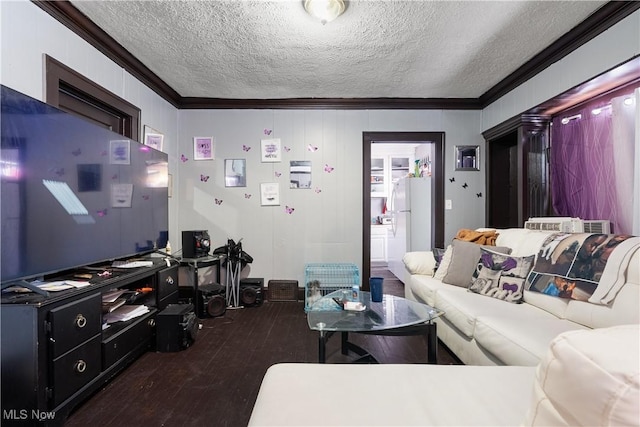 living room with crown molding, dark wood-type flooring, and a textured ceiling