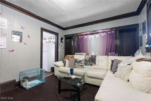 living room featuring ornamental molding, dark hardwood / wood-style flooring, and a textured ceiling