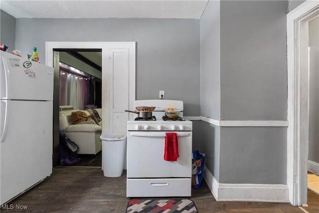 kitchen featuring dark hardwood / wood-style flooring and white appliances