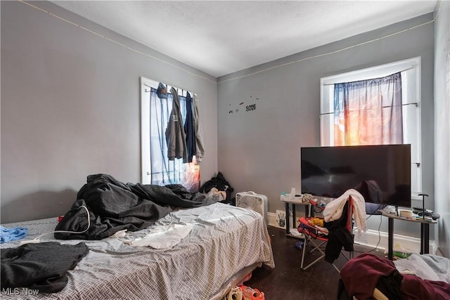 bedroom with hardwood / wood-style flooring