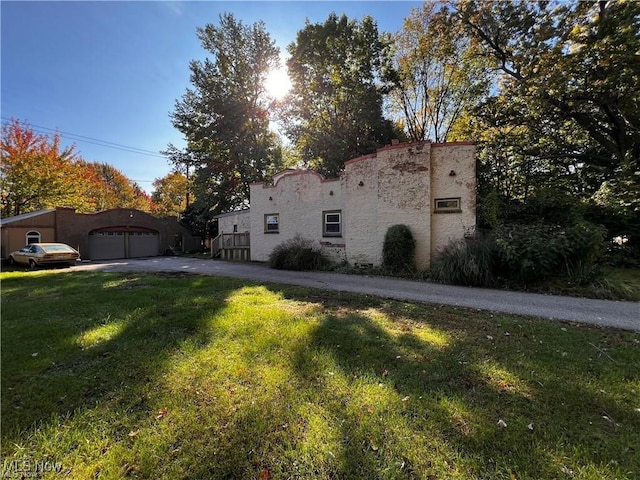 view of home's exterior with a yard and a garage