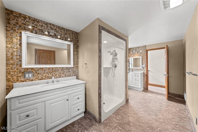 bathroom with vanity and a shower