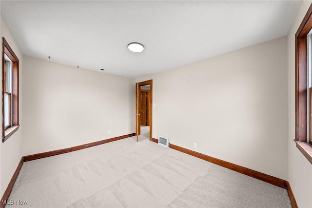 unfurnished room with light carpet