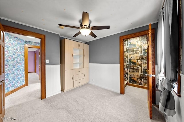 carpeted bedroom featuring ceiling fan and ornamental molding