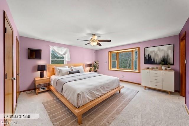 bedroom with light colored carpet and ceiling fan