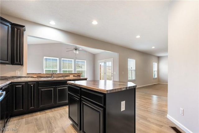 kitchen with a center island, a healthy amount of sunlight, and light wood-type flooring