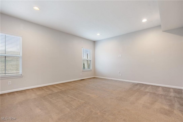 spare room featuring light colored carpet