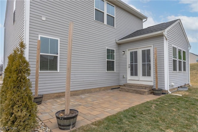 rear view of house with a lawn and a patio area