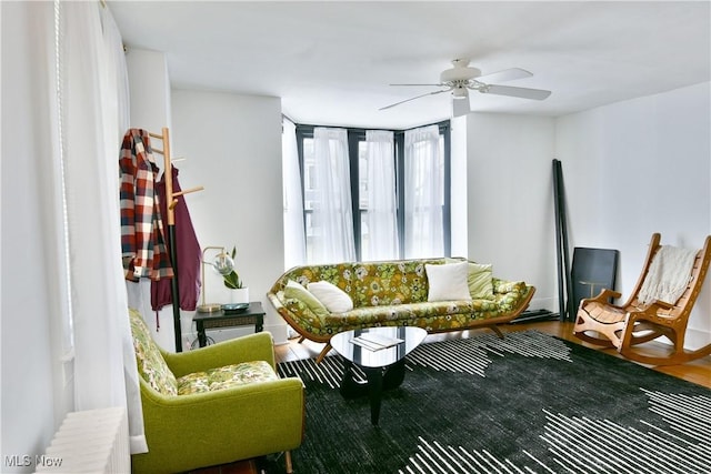 living room featuring hardwood / wood-style floors and ceiling fan