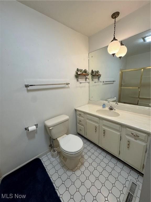 full bathroom with toilet, vanity, baseboards, tile patterned floors, and an enclosed shower