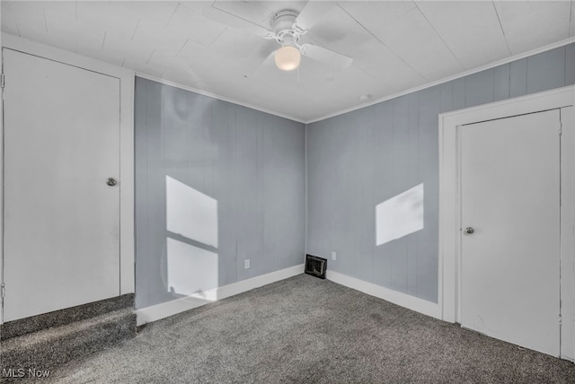 carpeted empty room with crown molding and ceiling fan