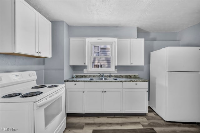 kitchen featuring white appliances, sink, and white cabinets