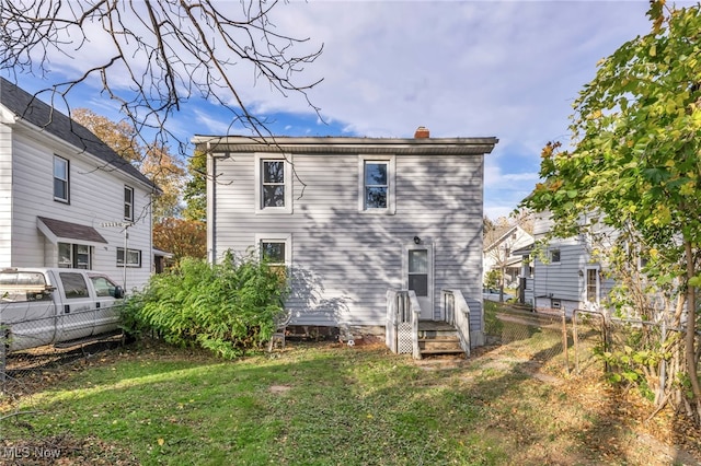 rear view of house with a yard