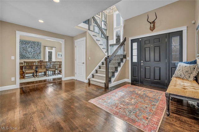 entrance foyer with stairs, baseboards, dark wood-type flooring, and recessed lighting