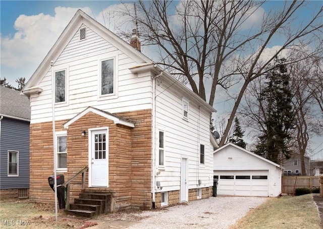 front facade with an outbuilding and a garage