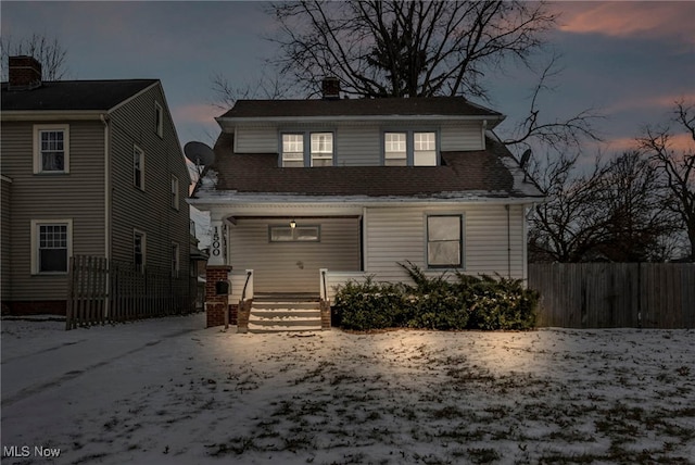 view of back house at dusk