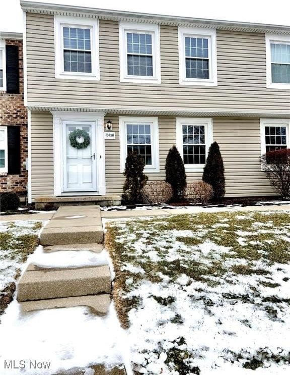 view of snow covered property entrance