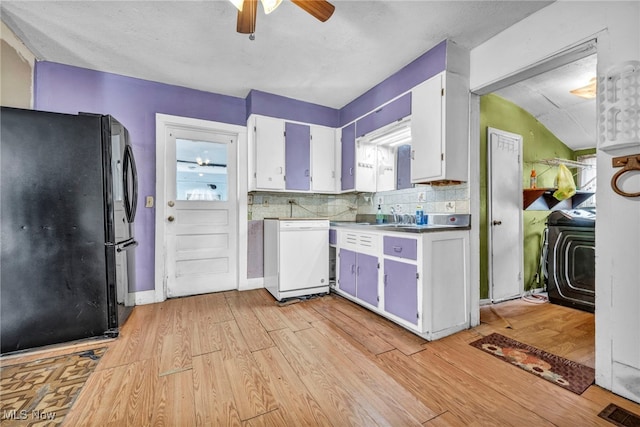 kitchen with black refrigerator, white dishwasher, light hardwood / wood-style floors, decorative backsplash, and white cabinets