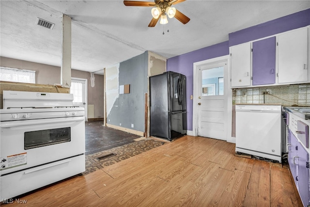 kitchen with white cabinetry, light hardwood / wood-style flooring, ceiling fan, white appliances, and decorative backsplash