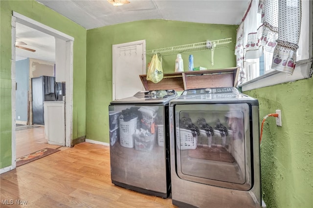 laundry room with washer and dryer, ceiling fan, and light hardwood / wood-style flooring