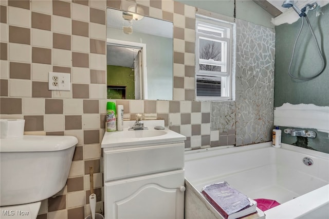 bathroom with a washtub, tile walls, vanity, decorative backsplash, and toilet