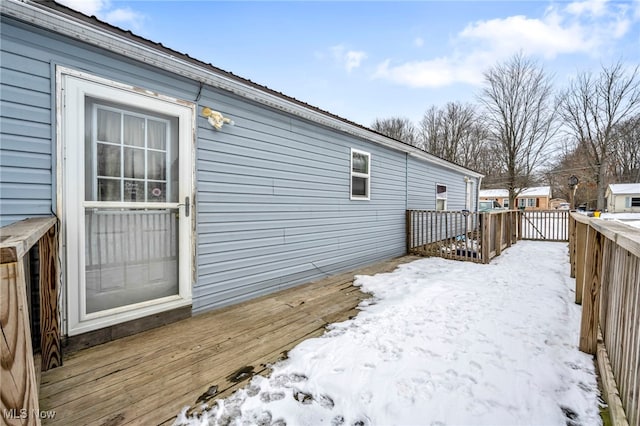 view of snowy exterior featuring a wooden deck