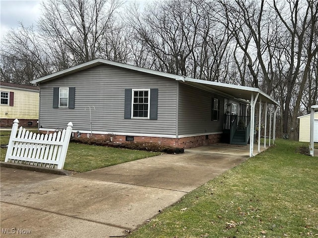 view of home's exterior with a carport and a lawn