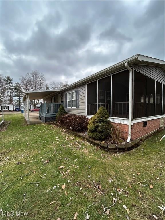 view of home's exterior featuring a yard and a carport