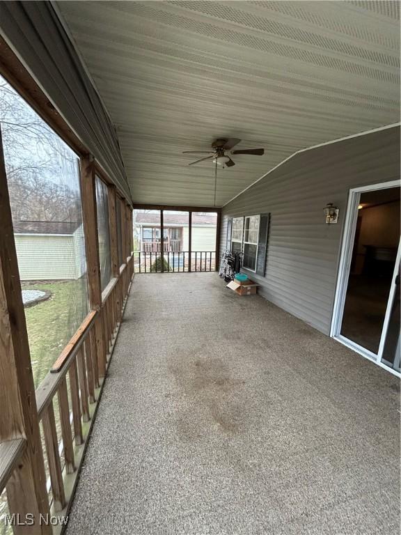 unfurnished sunroom featuring lofted ceiling and ceiling fan