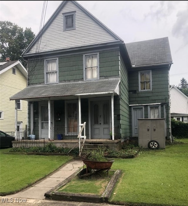 view of property with a porch and a front yard