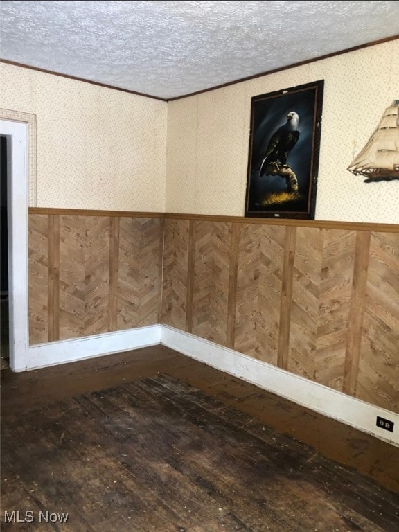 details with hardwood / wood-style flooring, crown molding, and a textured ceiling