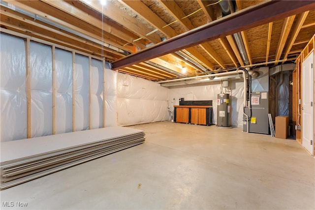 basement featuring water heater and heating unit