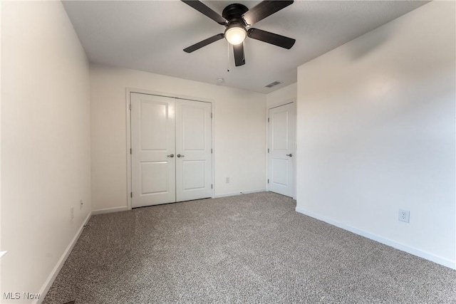 unfurnished bedroom with carpet floors, ceiling fan, and a closet