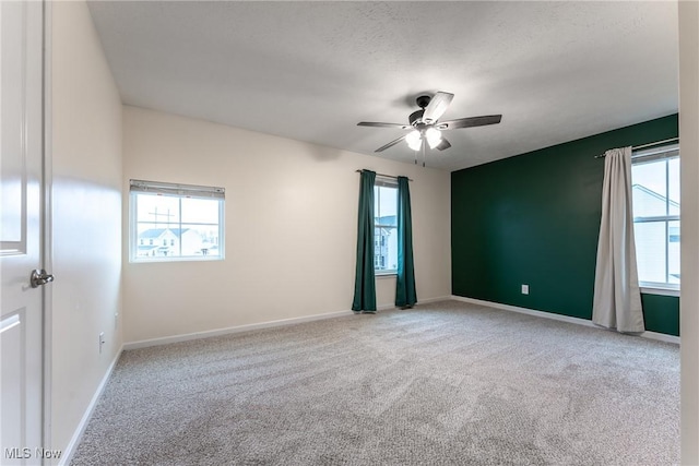 empty room featuring carpet and ceiling fan