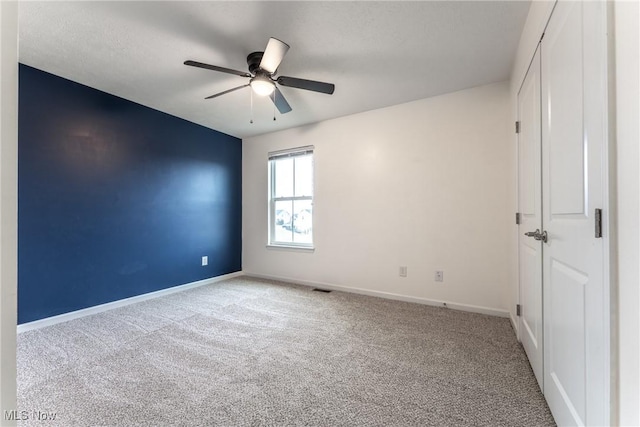 carpeted empty room with ceiling fan