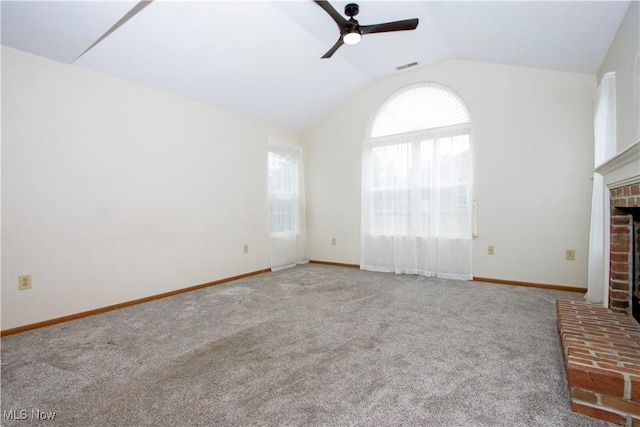 unfurnished living room with vaulted ceiling, carpet flooring, ceiling fan, and a fireplace