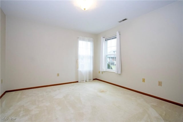 unfurnished room with light colored carpet