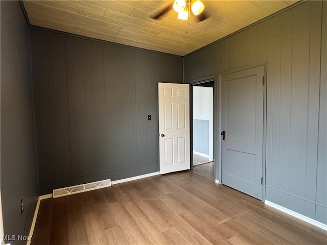 419 Saint Clair Ave, Cadiz, OH 43907 - spare room featuring wood finished floors, a ceiling fan, wood walls, baseboards, and wooden ceiling
