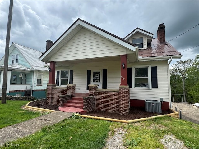 419 Saint Clair Ave, Cadiz, OH 43907 - bungalow-style house with a chimney, covered porch, central air condition unit, and metal roof