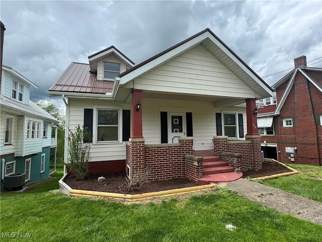 419 Saint Clair Ave, Cadiz, OH 43907 - bungalow-style home with a porch, central AC unit, a front yard, and metal roof