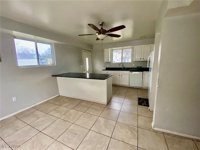 kitchen featuring ceiling fan, white dishwasher, white cabinets, light tile patterned flooring, and kitchen peninsula