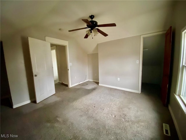 unfurnished bedroom featuring vaulted ceiling, ceiling fan, and dark carpet