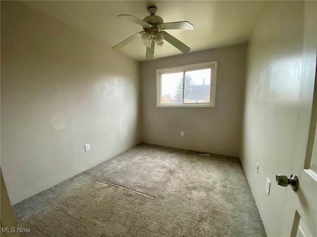 spare room featuring ceiling fan and light colored carpet