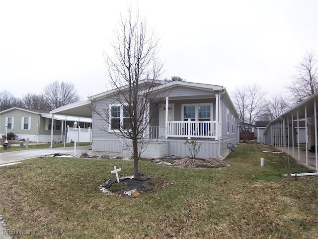 view of front of home with a carport, covered porch, and a front lawn