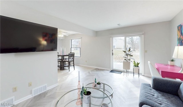 living room featuring plenty of natural light and light parquet floors