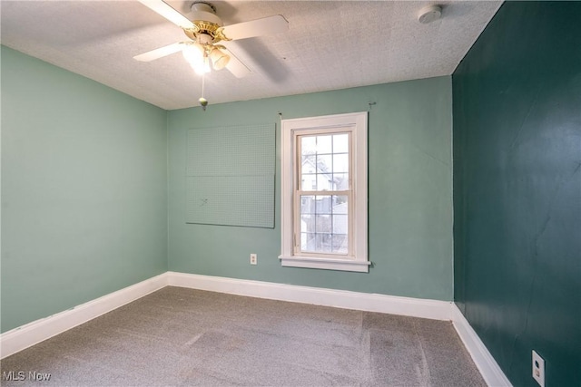 carpeted spare room with ceiling fan and a textured ceiling