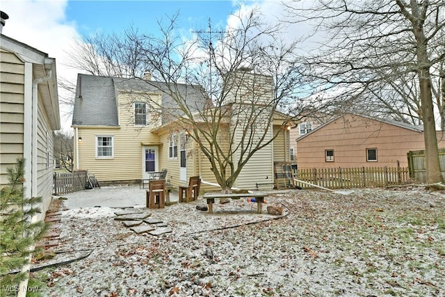 view of snow covered rear of property